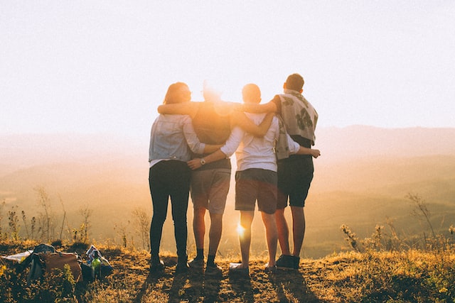 image of four friends hugging